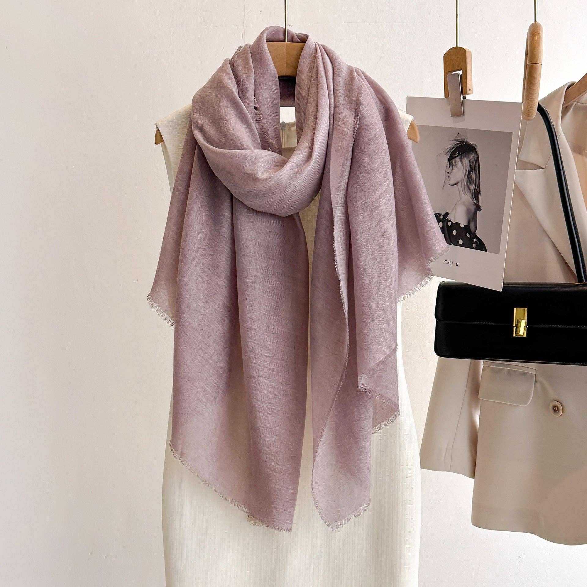 Leather purple fringed scarf on a hanger at Dover Grace Boutique in Watkinsville, Georgia.