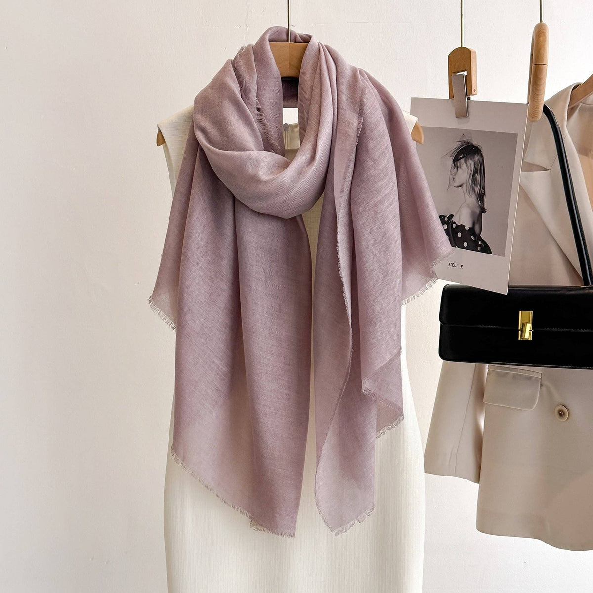 Leather purple fringed scarf on a hanger at Dover Grace Boutique in Watkinsville, Georgia.