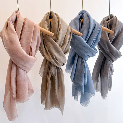 Pink, taupe, blue and gray fringed scarves at Dover Grace Boutique in Watkinsville, Georgia.