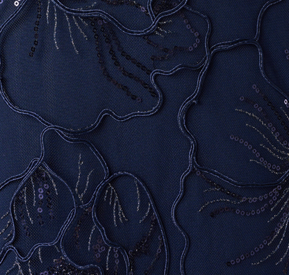 Close-up of navy gown with embroidered floral detail at Dover Grace Boutique in Watkinsville, GA.