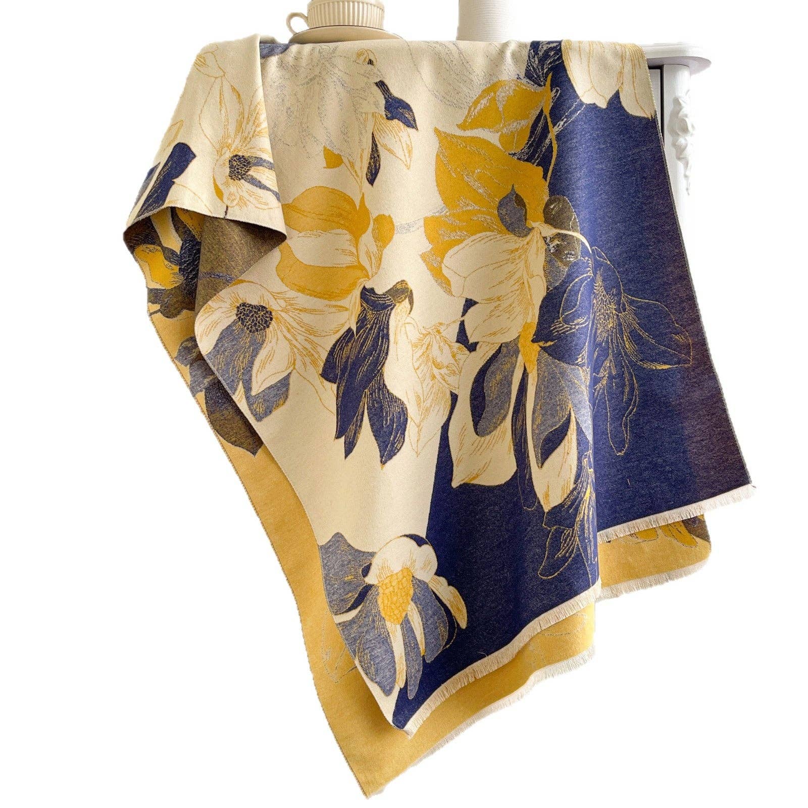 Navy and yellow floral scarf on white backdrop at Dover Grace Boutique in Watkinsville, Georgia.