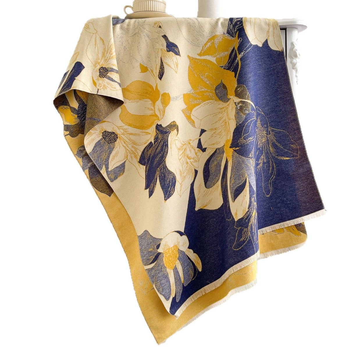 Navy and yellow floral scarf on white backdrop at Dover Grace Boutique in Watkinsville, Georgia.