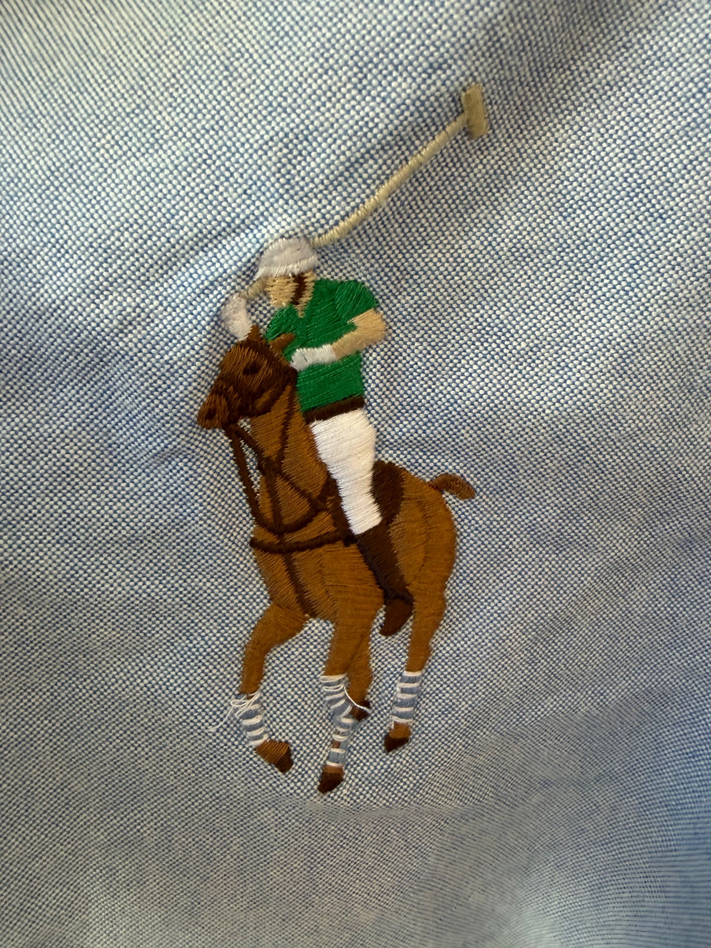Embroidered polo player in green and white on a light blue Ralph Lauren oxford shirt