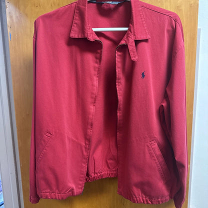 Red jacket with a brand logo on a wooden door