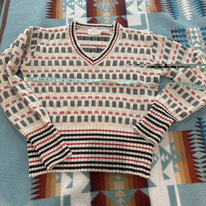 Striped sweater on a patterned fabric background