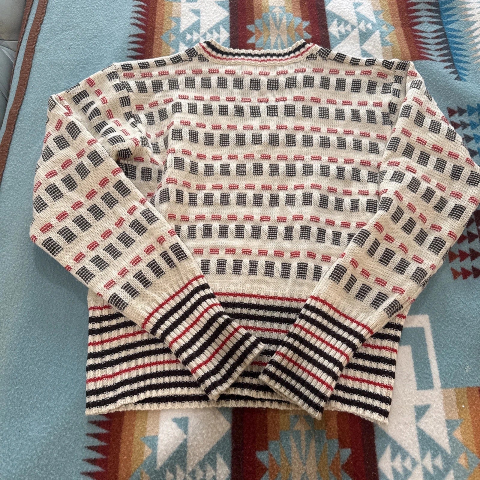 Patterned sweater on a colorful fabric background