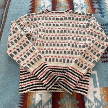 Patterned sweater on a colorful fabric background