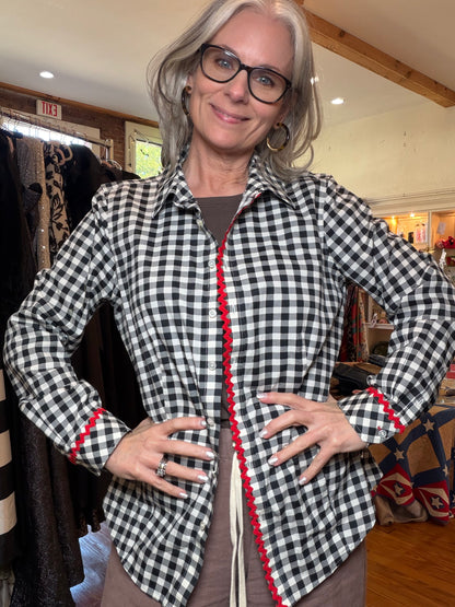 Black and white gingham button-up shirt with red rickrack along the front placket and cuffs.