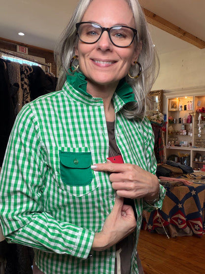 Green gingham shirt with a solid green flap pocket and ruffled collar, shown from the front.