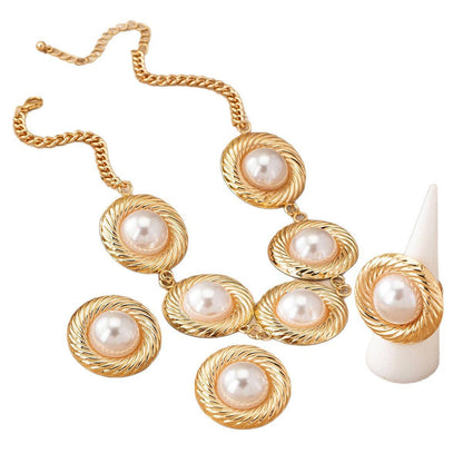 White pearl gold-tone necklace on white backdrop at Dover Grace Boutique in Watkinsville, Georgia.