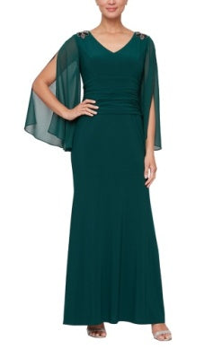 A floor-length dark teal gown featuring a V-neckline, embellished shoulders, a gathered waist, and sheer split-sleeve cape details.